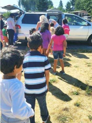 Kids waiting in Line for food from the Summer Lunch van