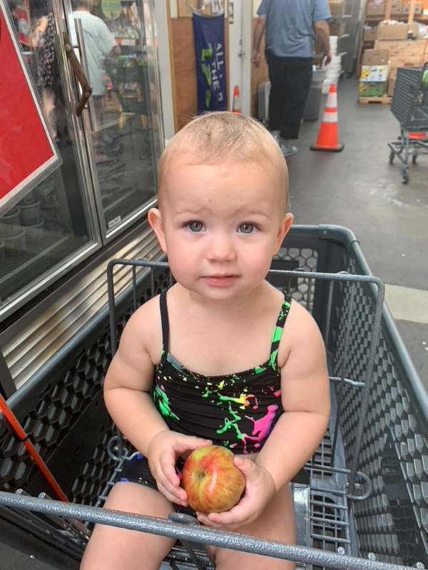 Adorable Baby Shopper with Apple