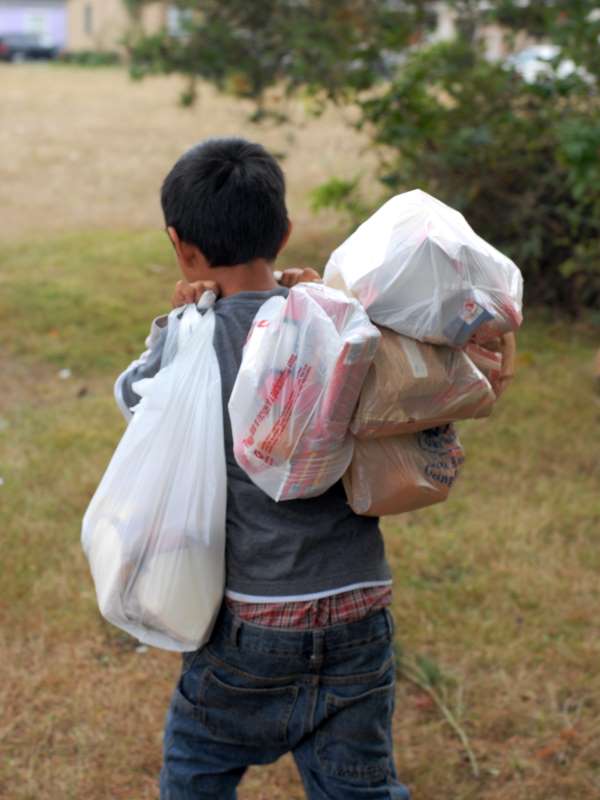 Boy With Armload of Summer Lunches