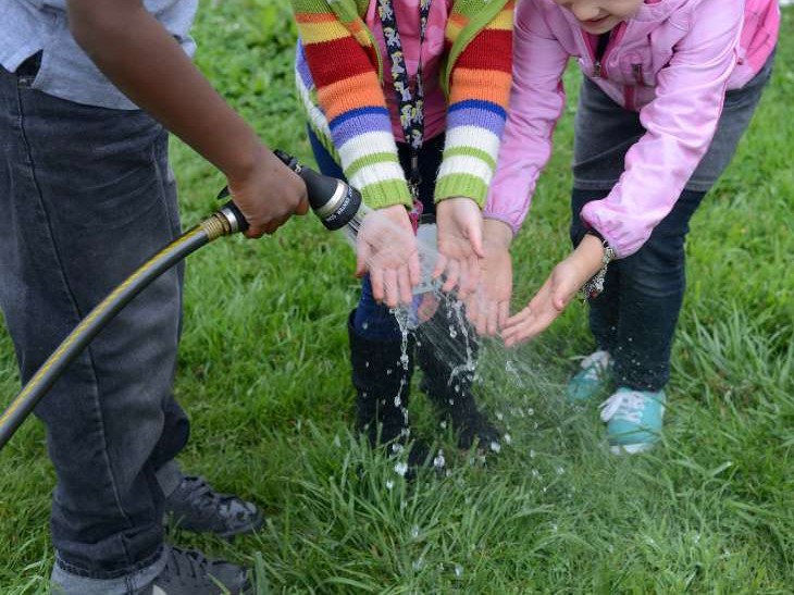 Kids Washing Hands With Garden Hose