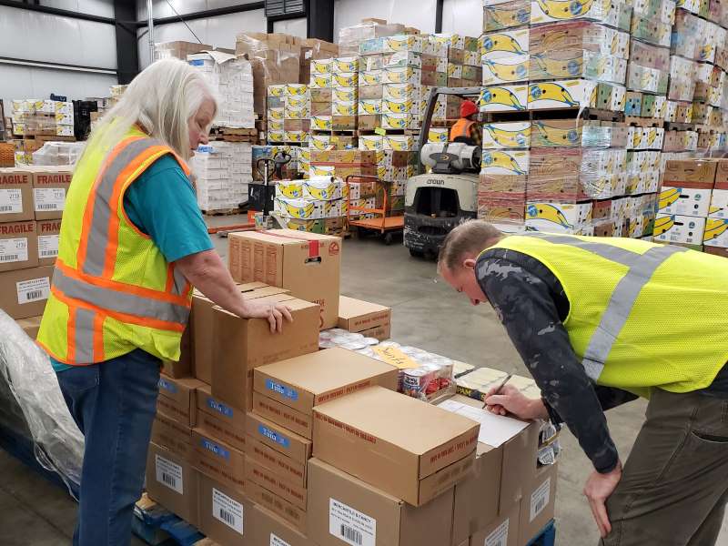 Warehouse Volunteers Preparing Orders for Distribution